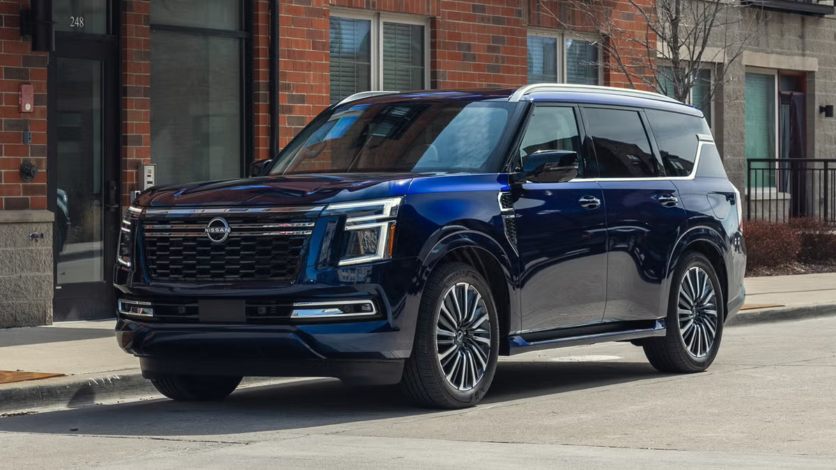 2027 Nissan Armada in dark blue, front three-quarter view on a city street