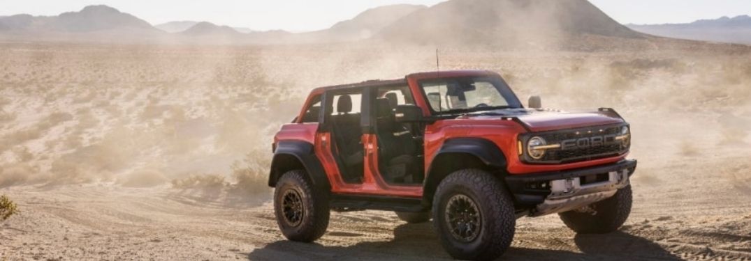 A red Ford Bronco® Raptor™ in the desert.