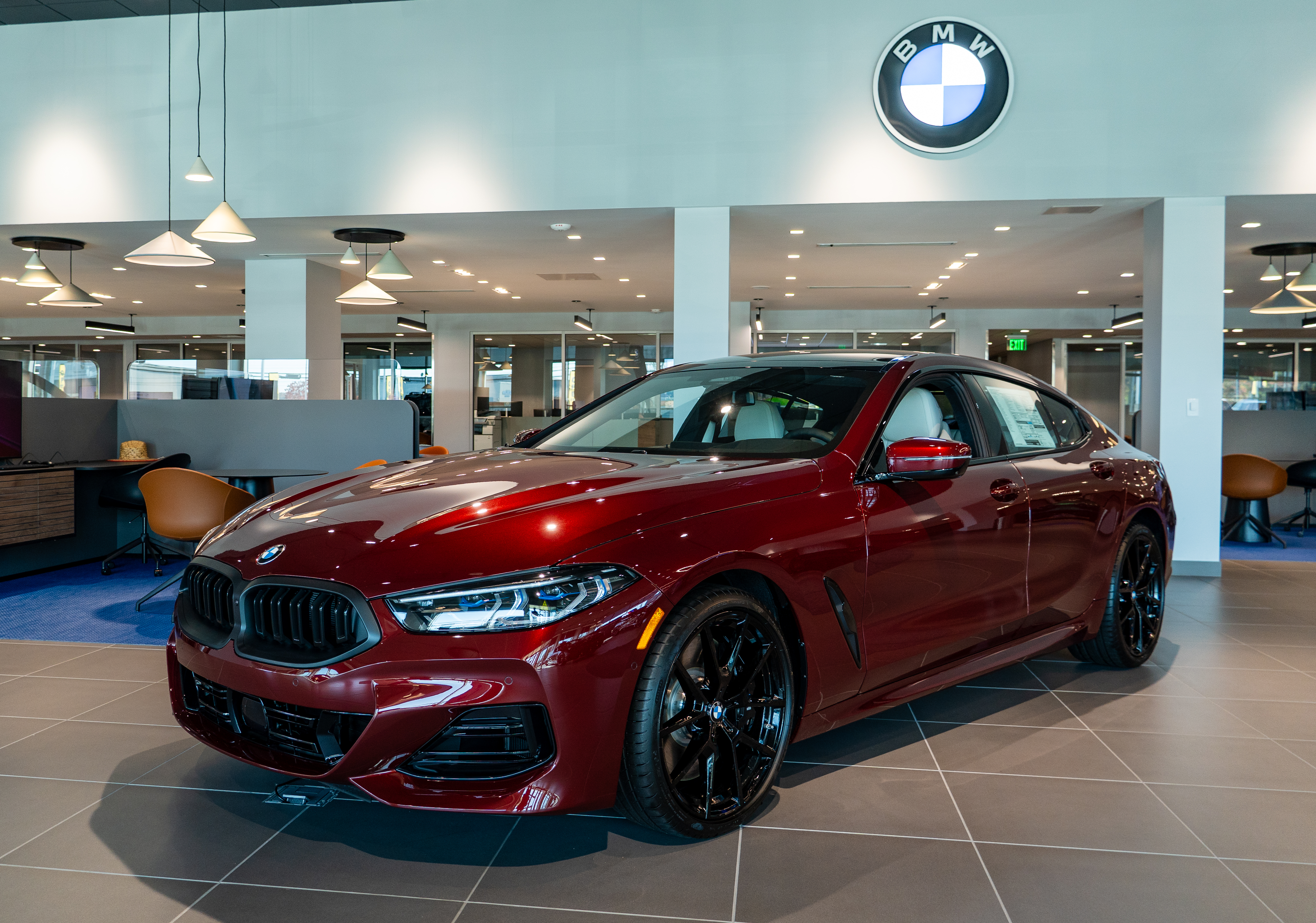 A red BMW car in the BMW of Greensboro showroom