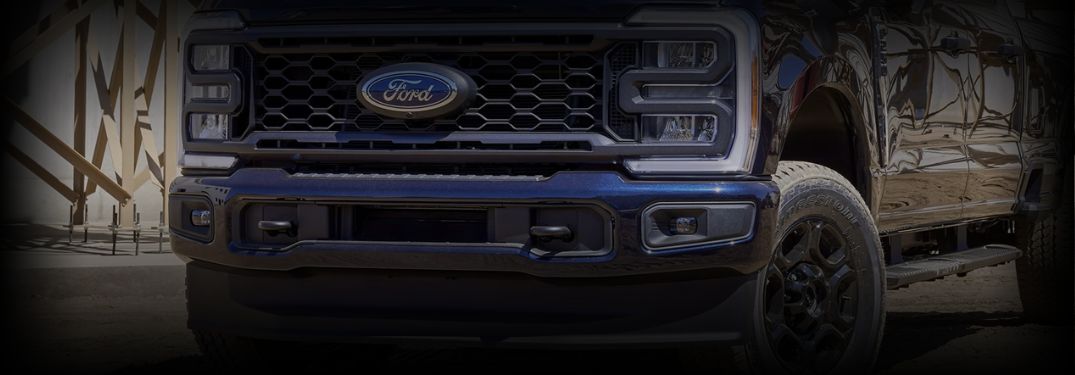 Close Up of Blue Ford Super Duty Grille and Badge with Shadows