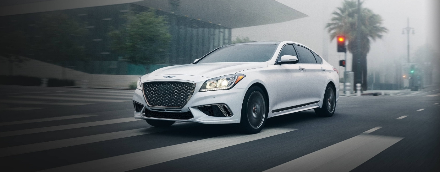 White 2020 Genesis G80 driving through an intersection