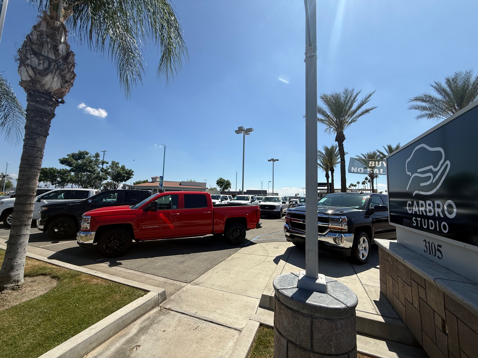Sales team assisting a customer with a used truck purchase