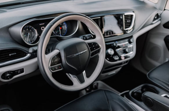 A steering of car is visible with other car interior