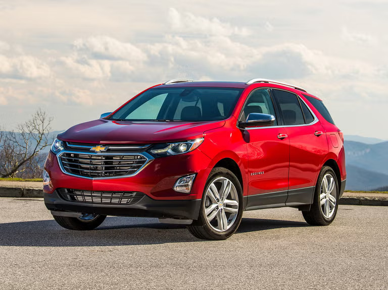 A red Chevrolet Equinox parked.