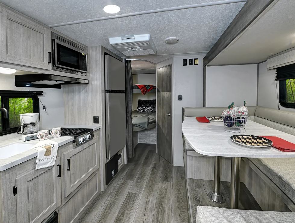 Coachmen Catalina Expedition travel trailer 192BHS interior from front to back; view from kitchen looking towards bunk beds and bathroom