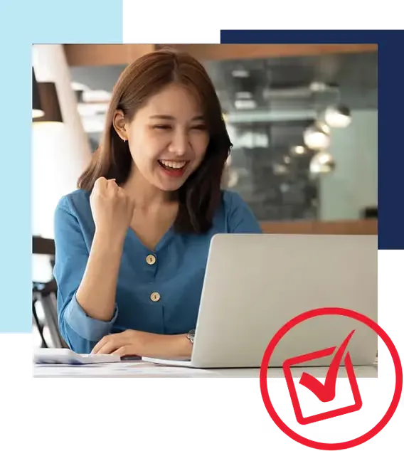 It's easy to get prequalified at Holiday Automotive. Woman smiling while looking at laptop and pumping fist in excitement. Red icon in the lower right corner of checked checkbox in circle.