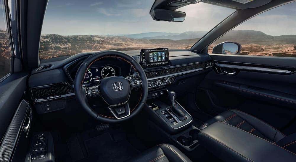 The black interior and dash of a 2023 Honda CR-V is shown.