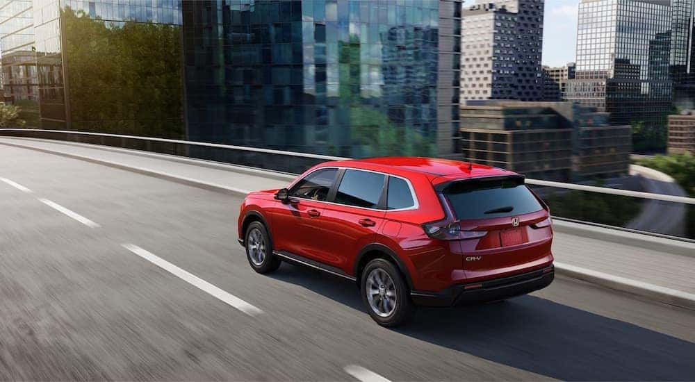 A red 2025 Honda CR-V is shown from the rear at an angle after leaving one of the Honda dealers in Rochester.