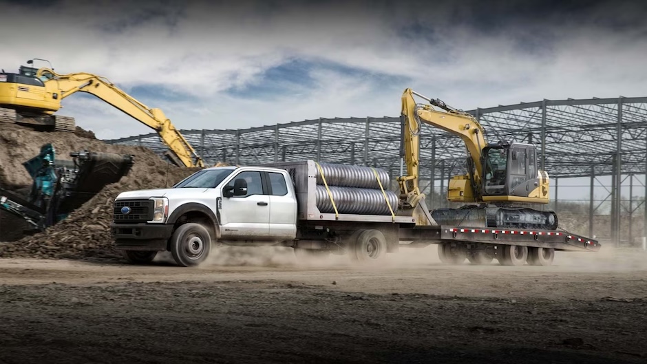 Ford towing flatbed trailer on construction jobsite