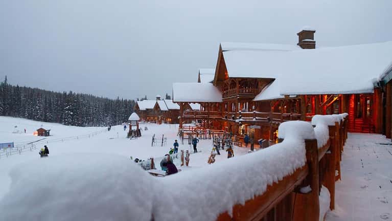 Snowy lodge with skiers at Lake Louise