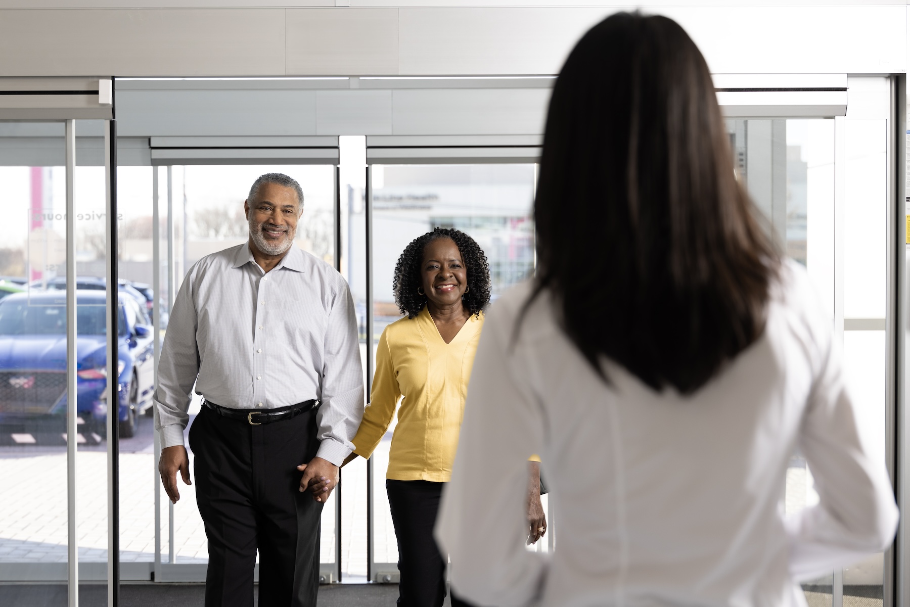 Couple walking up to sales associate