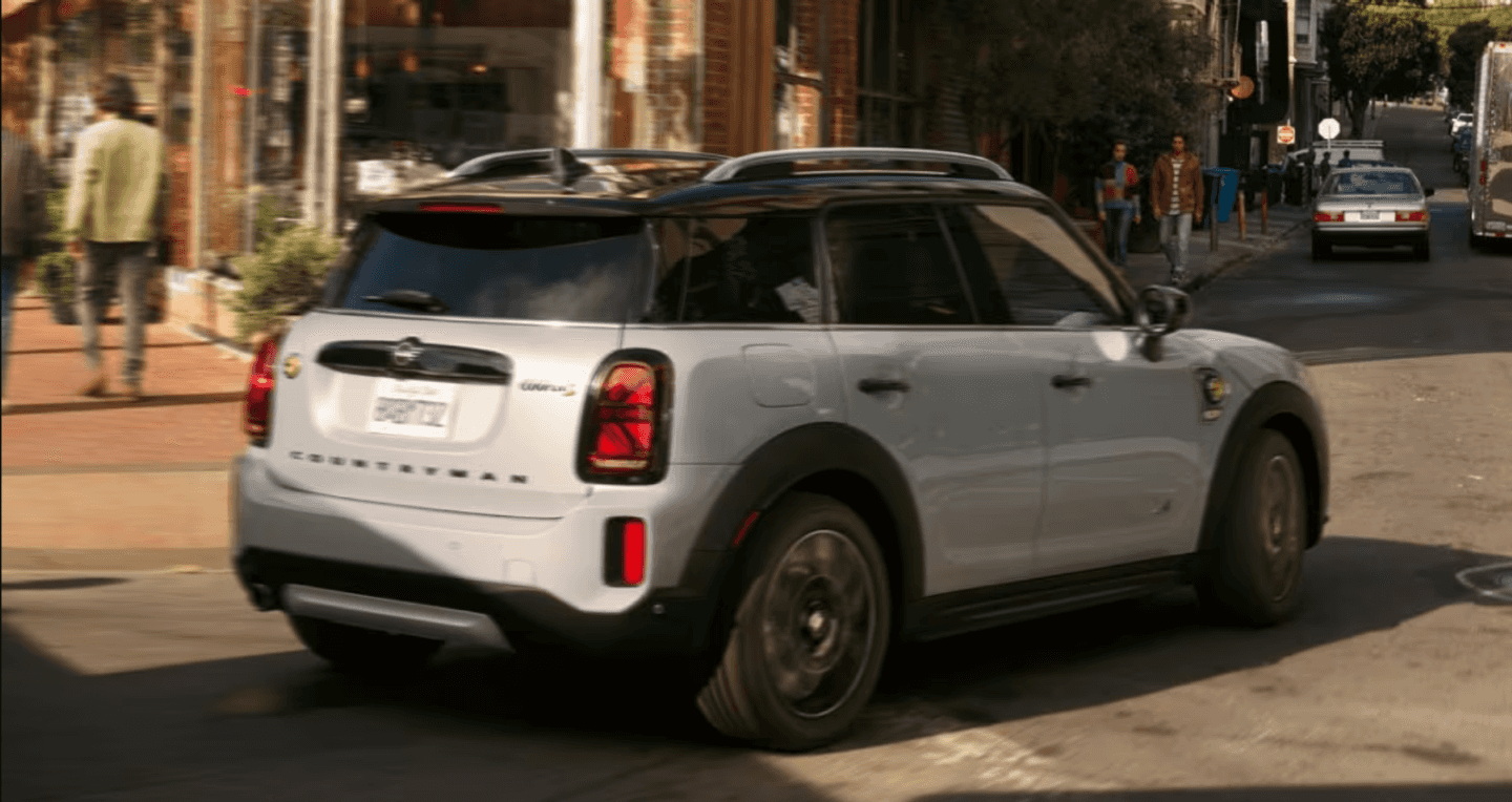 A 2023 MINI Countryman PHEV turning onto the street.