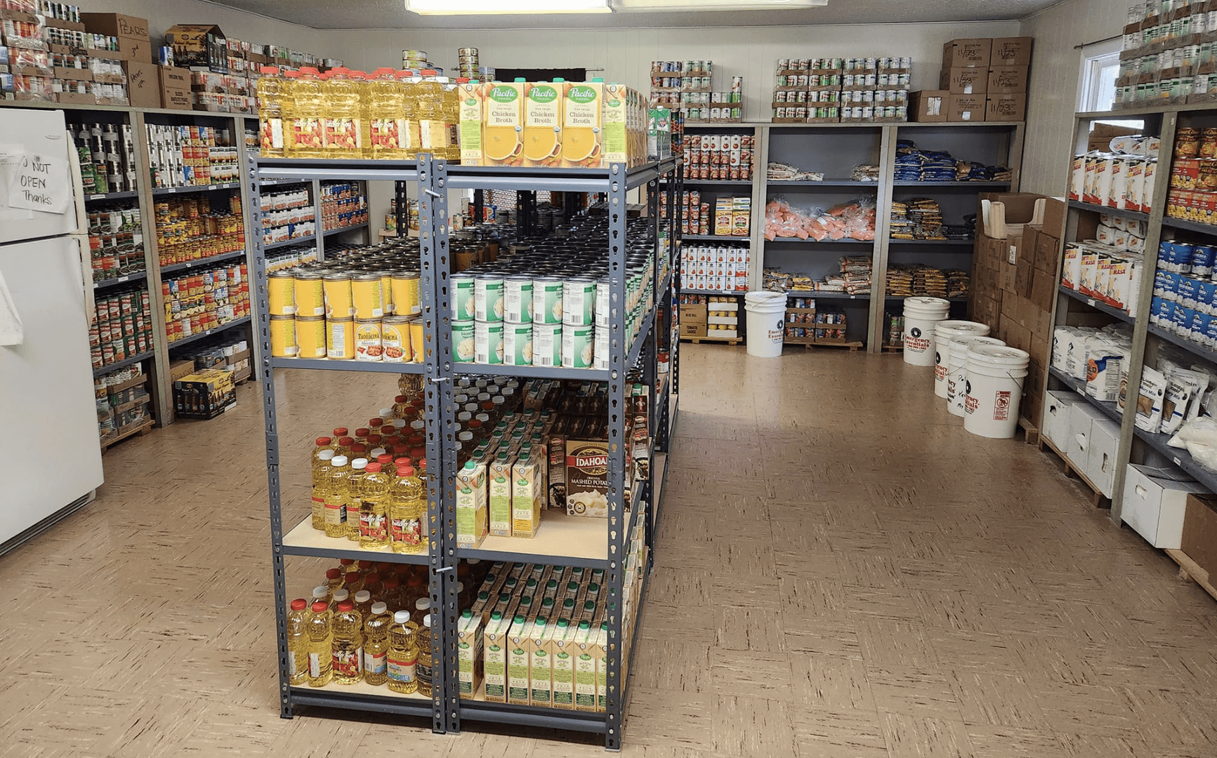 Food pantry shelves stocked with canned and boxed goods