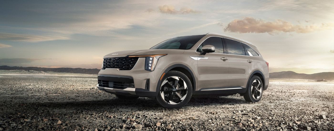  Tan 2025 Kia Sportage PHEV on gravel