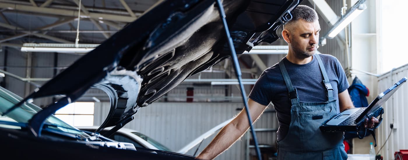 A mechanic is shown inspecting a vehicle during a Honda car service.