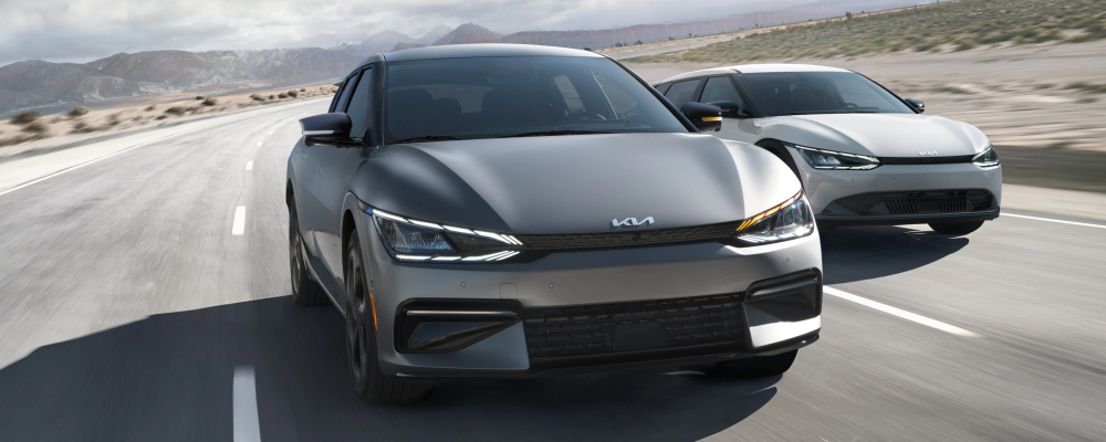 2022 Kia EV6 electric vehicles driving on a road, showcasing sleek design and performance features.