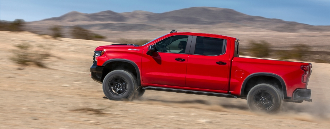 A red 2023 Chevy Silverado 1500 ZR2 is shown from the side.