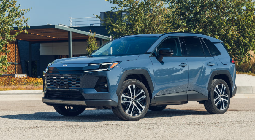 Blue 2026 Toyota RAV4 in front of a home