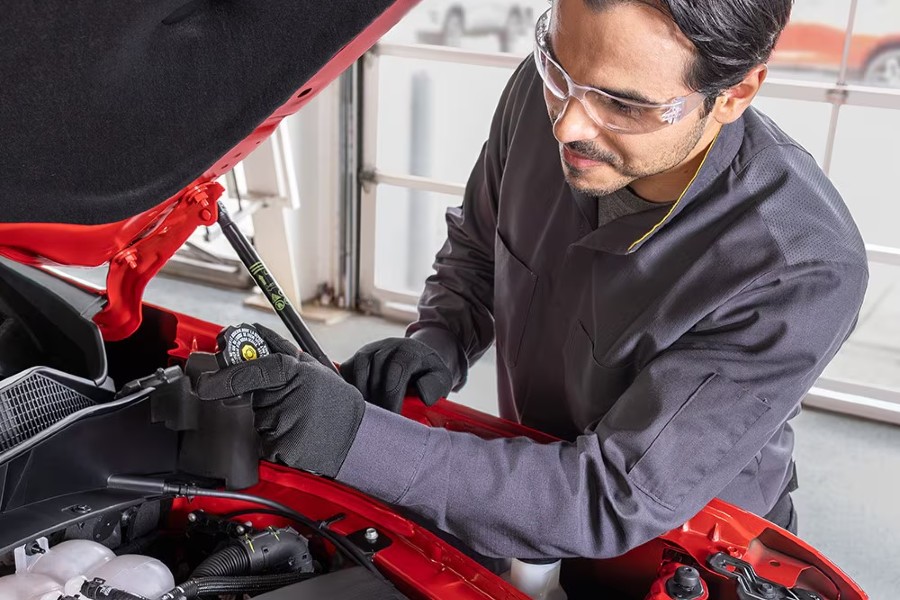 Chevrolet Certified Service Technician Working Under Hood