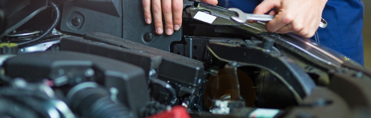Technicians working on a vehicle at Cox Chrysler Dodge Jeep Ram