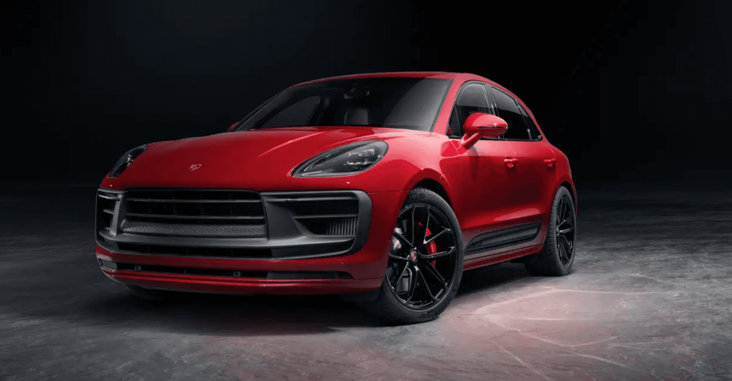 A red Porsche Macan on a gray surface.