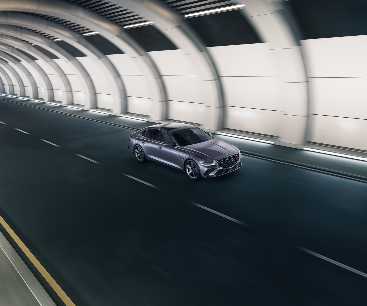 High 3/4 front passenger side view of Genesis G80 in Ceres Blue driving through tunnel