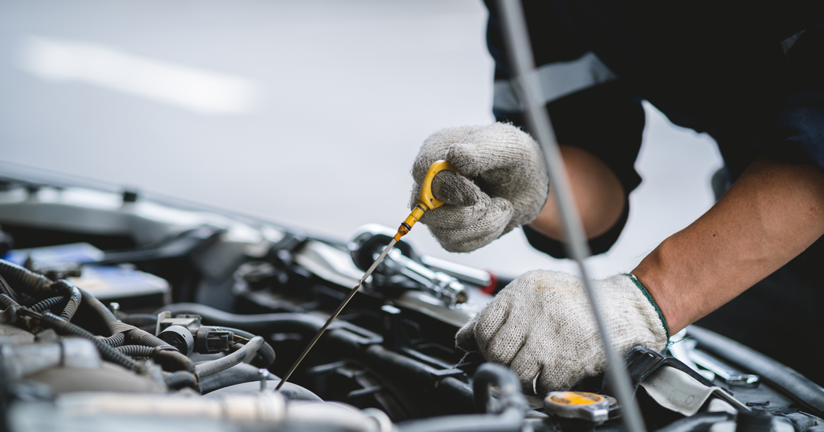 BMW service technician performing an oil change
