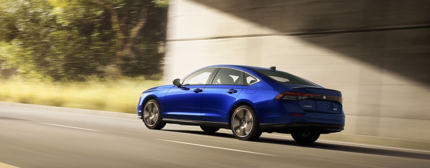 A blue 2023 Honda Accord is shown from the rear at an angle.