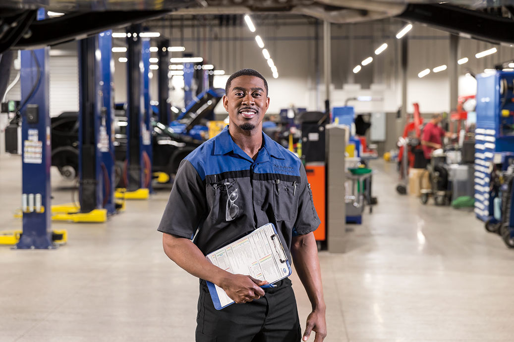 Image of service representative smiling and holding a clipboard.