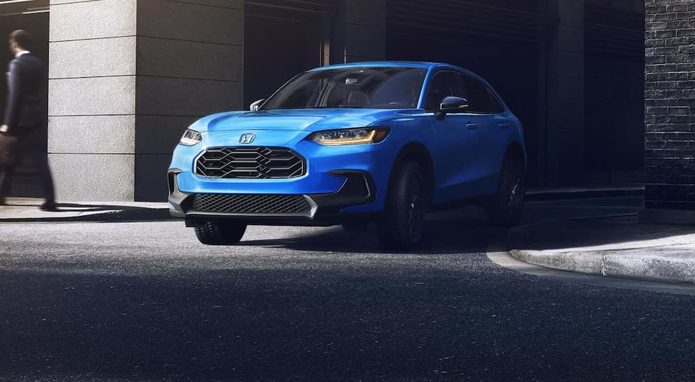 Blue 2027 Honda HR-V driving out of an alleyway.