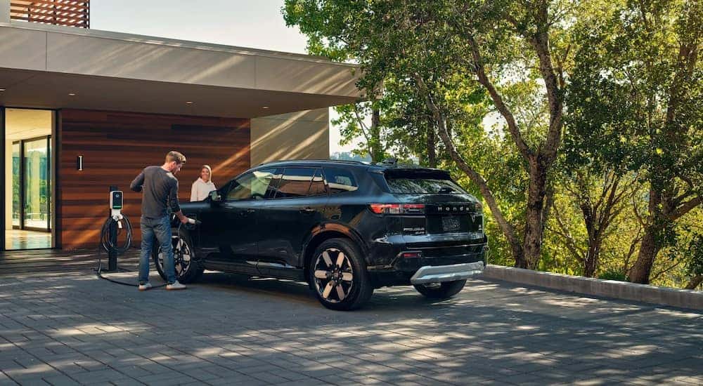 A black 2024 Honda Prologue Elite is shown parked on a driveway.