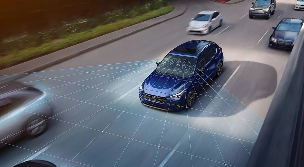 Simulated EyeSight sensors are shown coming from a blue 2024 Subaru Impreza.