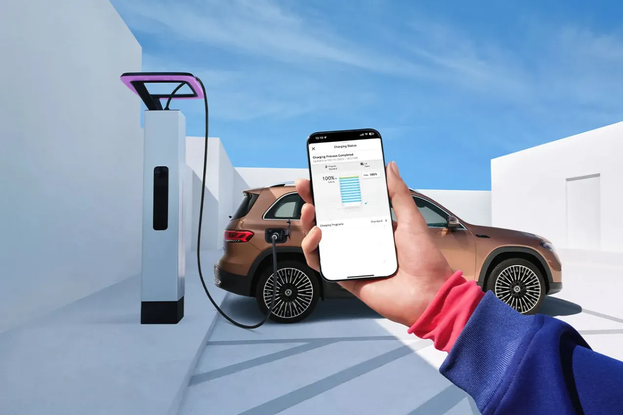 Hand holding smartphone in front of charging station