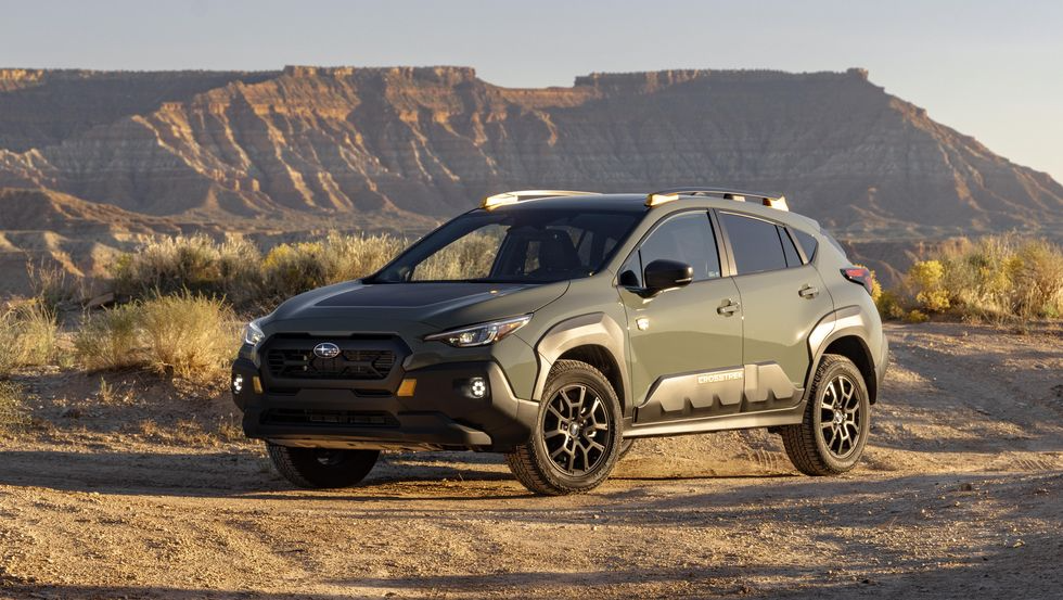 Green 2024 Subaru Crosstrek Wilderness parked on a desert plateau