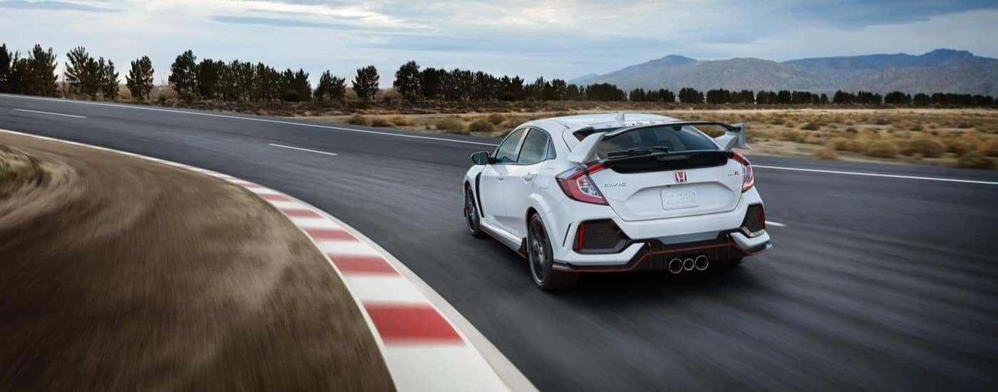 A white 2021 Honda Civic Type R is shown from the rear on a racetrack.
