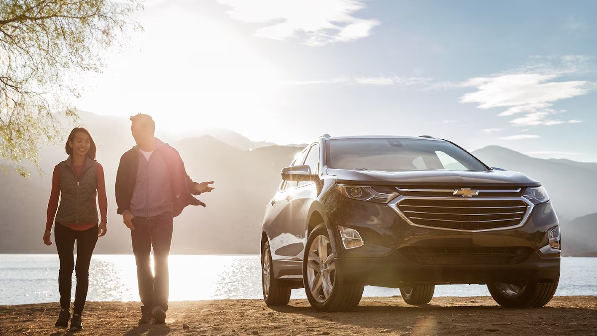 2018 Chevy SUV Exterior Passenger Side Front Angle with Owners Nearby