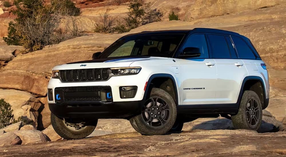 A white 2024 Jeep Grand Cherokee 4xe is shown from the front at an angle after leaving a Jeep dealership near me.