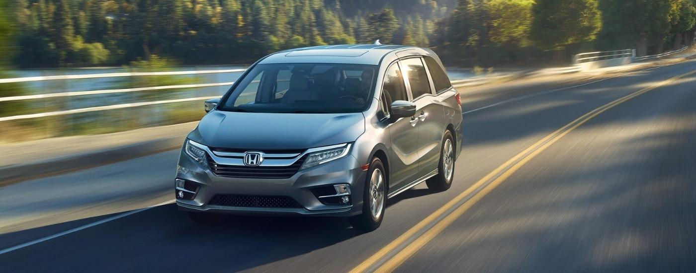 silver 2018 Honda Odyssey is shown driving on a highway