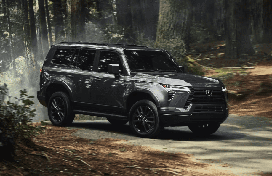 Side view of the 2024 Lexus GX driving through a forest