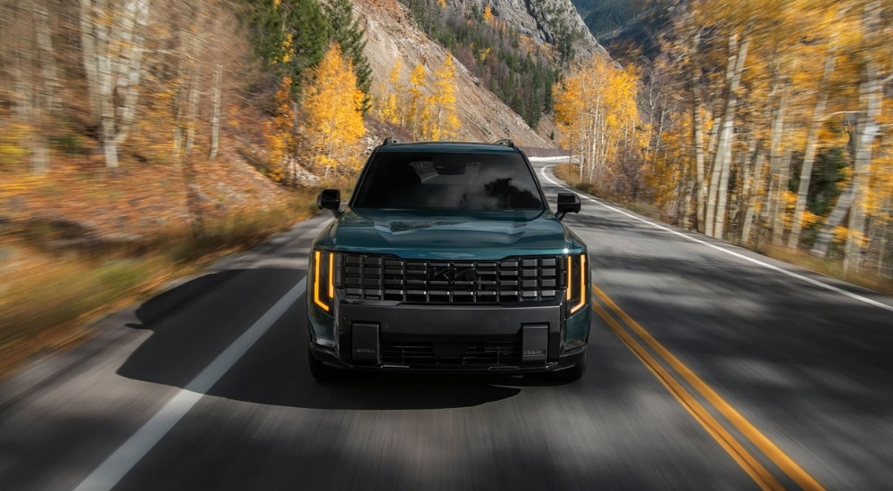 Green 2027 Kia Telluride for sale in Brooklyn Park driving on a highway