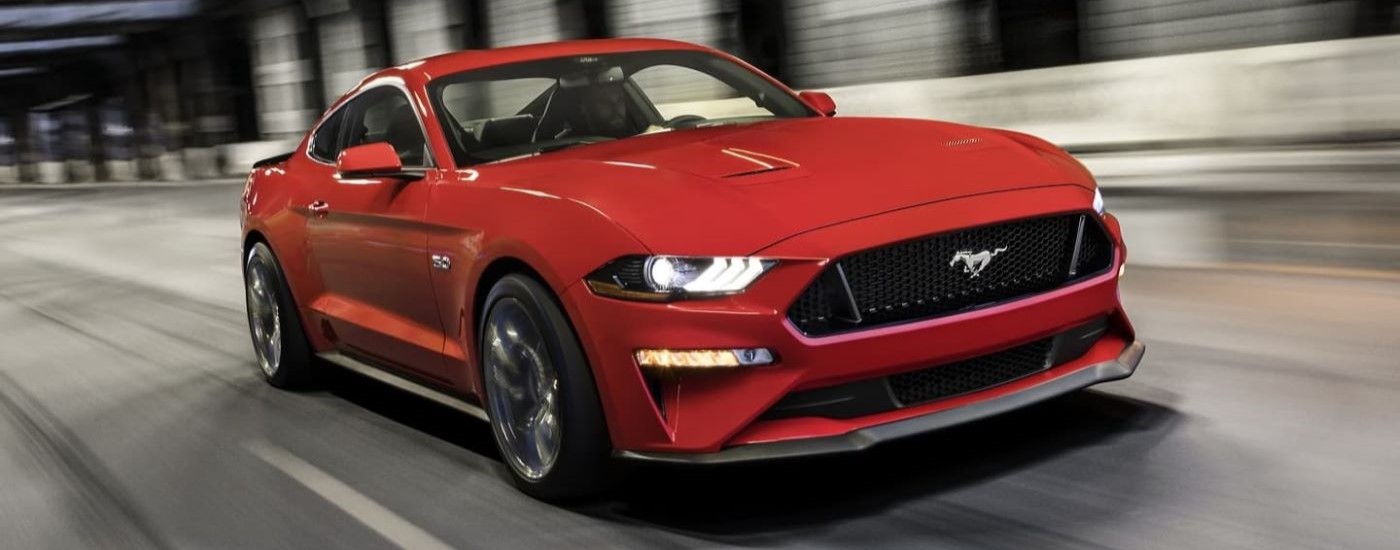 An red 2021 Ford Mustang Ecoboost HPP is shown from the front at an angle after leaving a used car dealer near Shiprock.