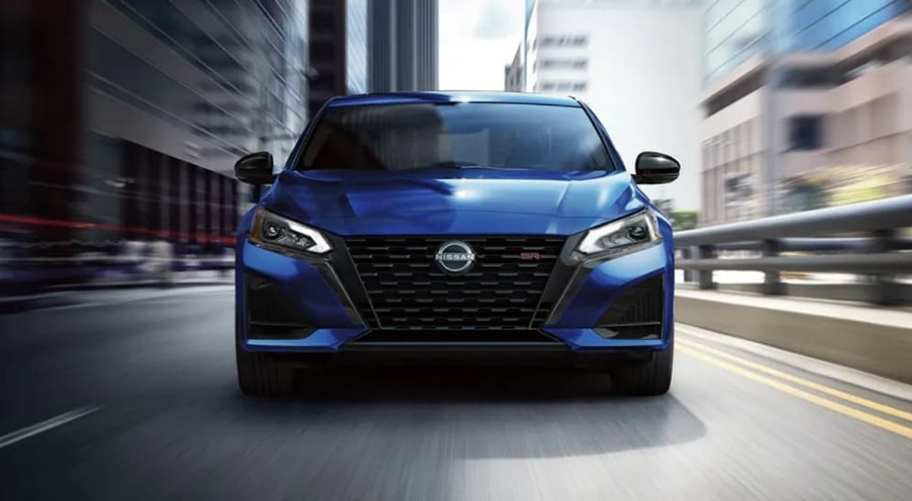 Blue 2024 Nissan Altima SR driving in a city