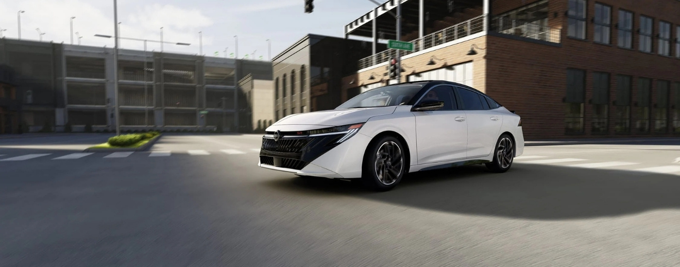 White 2026 Nissan Sentra SR driving through an intersection
