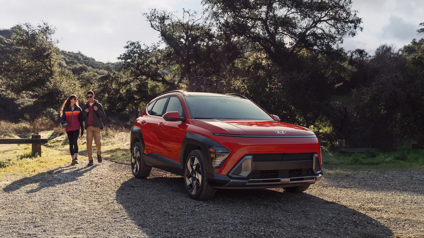 An orange Kona sitting parked.
