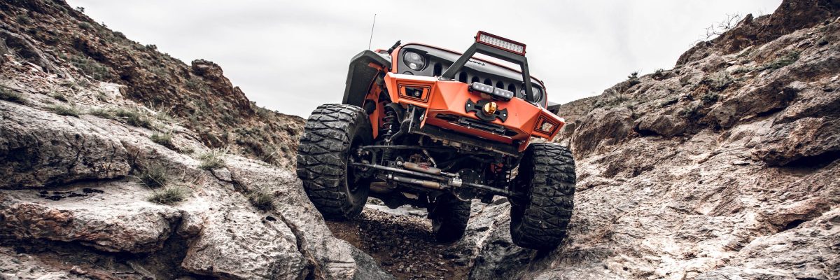 Orange Lifted Jeep Rock Crawling