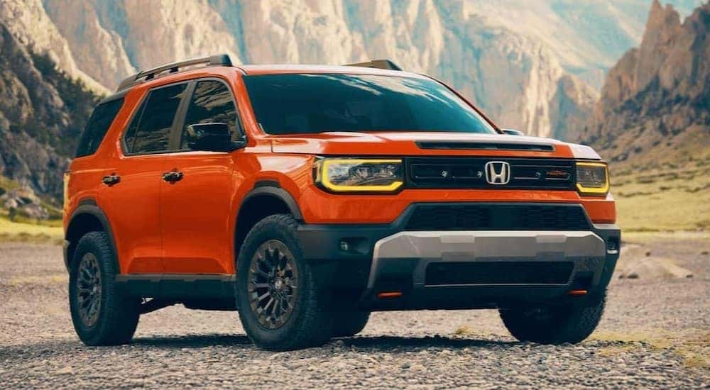 An orange 2026 Honda Passport TrailSport Elite is shown parked after viewing a Honda Passport for sale in Rochester.