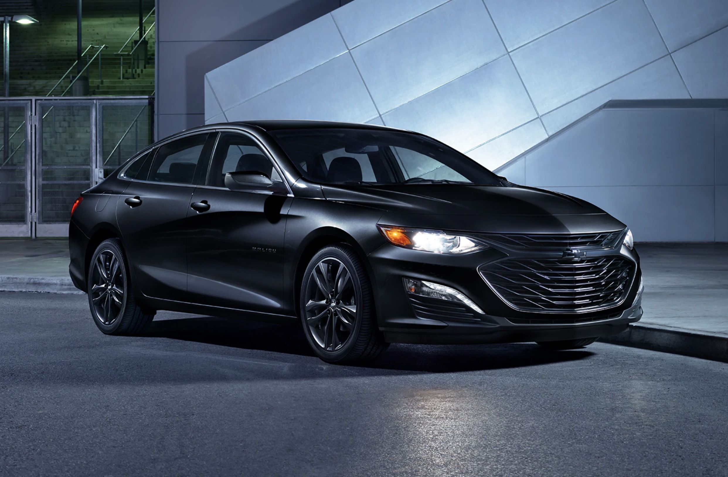 A black Chevrolet Malibu parked.