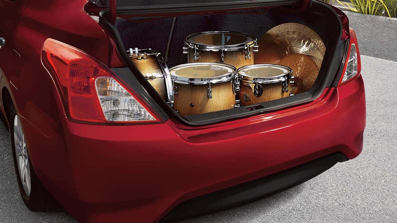 Red 2017 Nissan Versa sedan with the trunk open