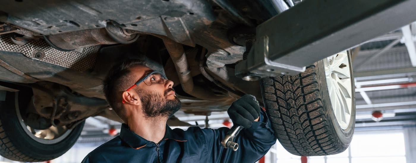 Mechanic inspecting a set of tires on a lift