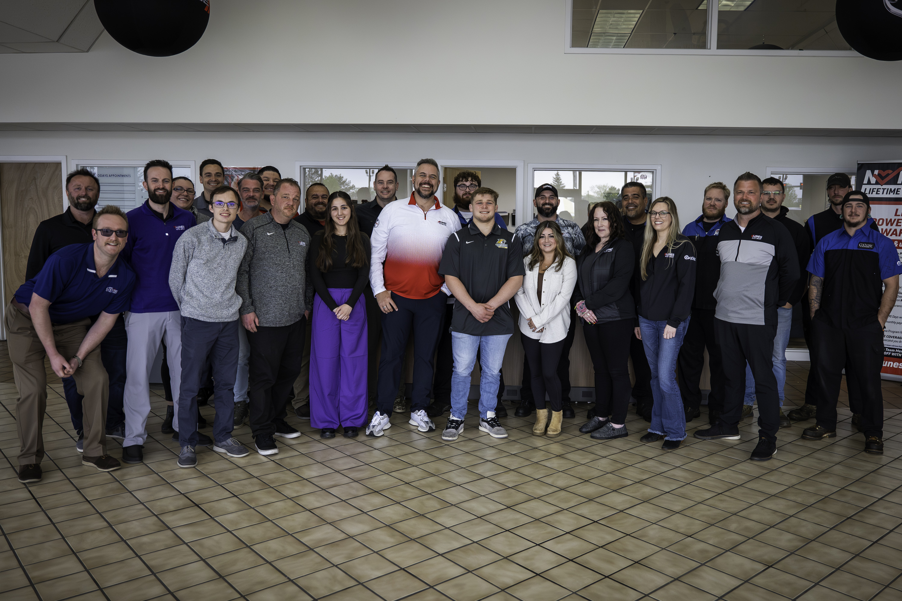 Payton Jacobson, Team USA Greco-Roman Olympic Wrestler and Scott Kunes, COO of Kunes Auto & RV Group, pictured in the middle of the dealership team from Kunes CDJR of Elkhorn, WI